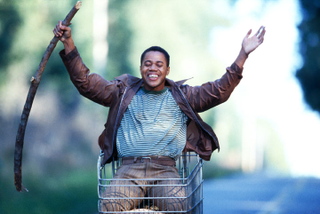 We have no idea why Cuba Gooding Jr. is riding in a shopping cart in this still from the film Radio, and fear that learning the answer would involve watching Radio